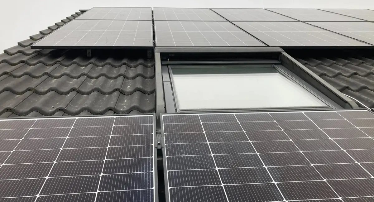 Solarmodule auf Ziegeldach um ein Dachfenster